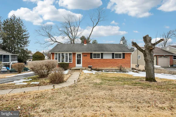 a view of a house with a yard covered in snow