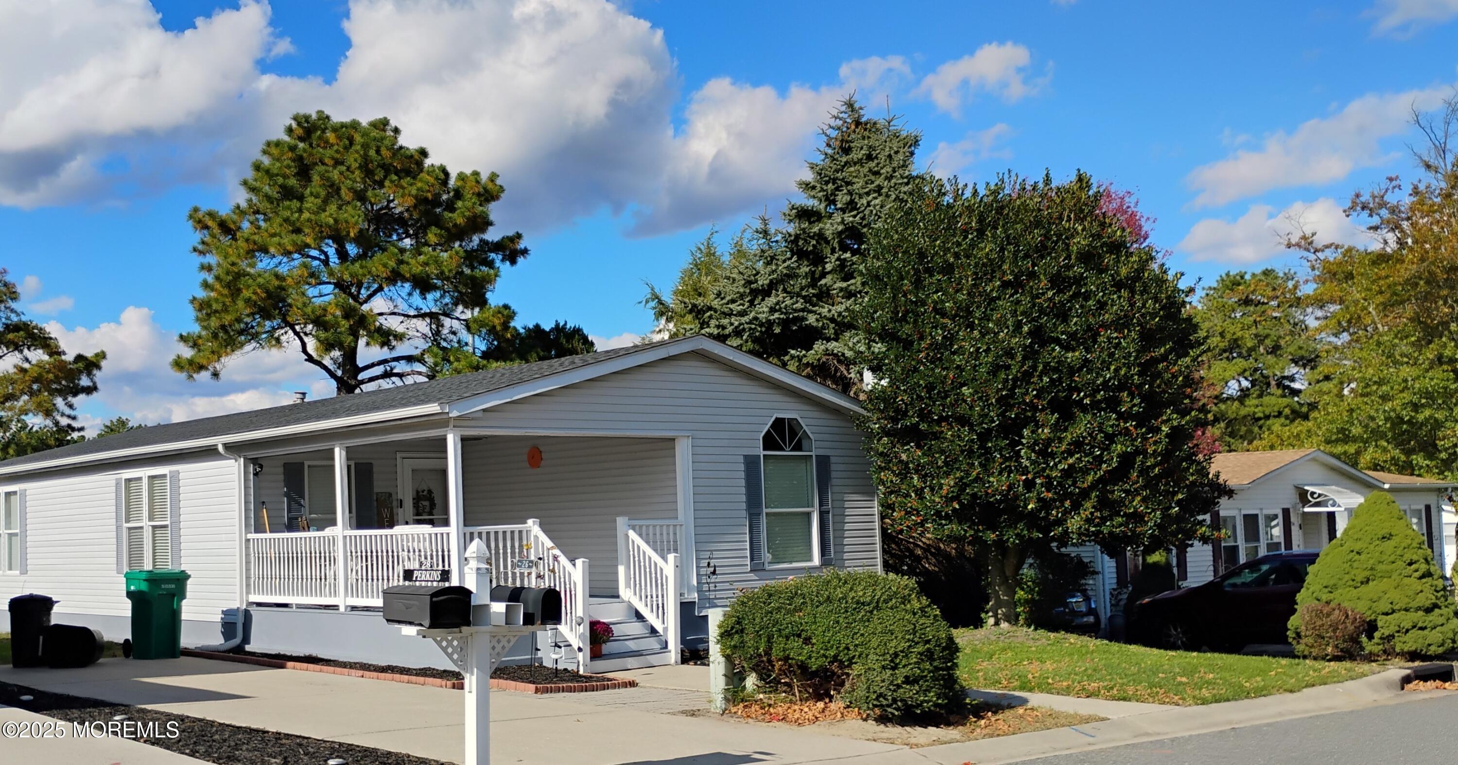 26 Pine Ridge Boulevard Whiting, NJ 08759 - Photo 2 of 16 a front view of a house with a yard