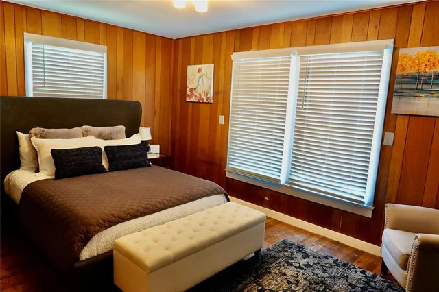 a bed room with a bed and a chair