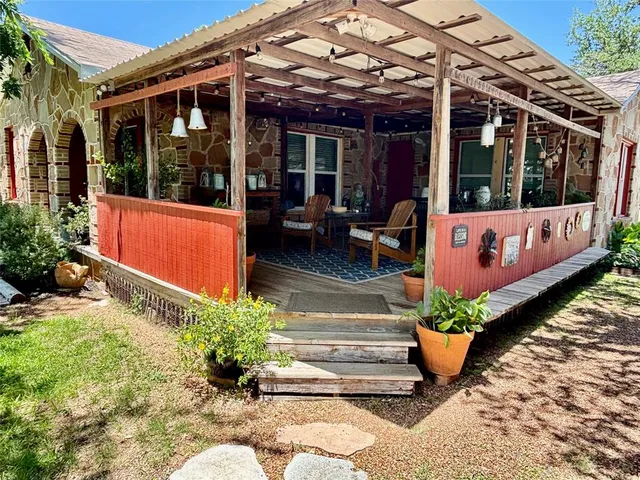 a front view of a house with plants