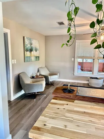 a living room with furniture and a potted plant