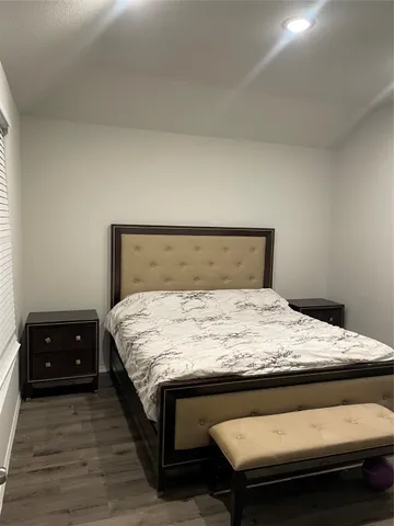 a bedroom with a bed and a dressers