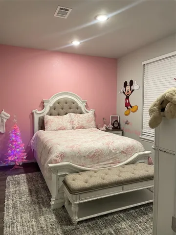 a bedroom with a bed and a couch