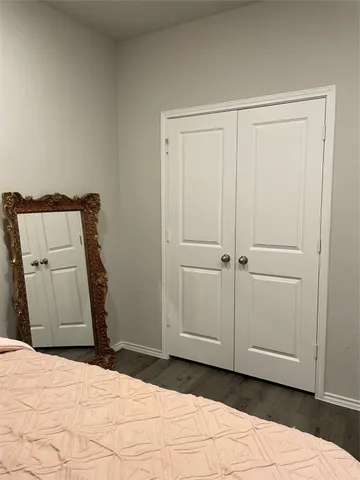 a bedroom with a bed and a cabinet