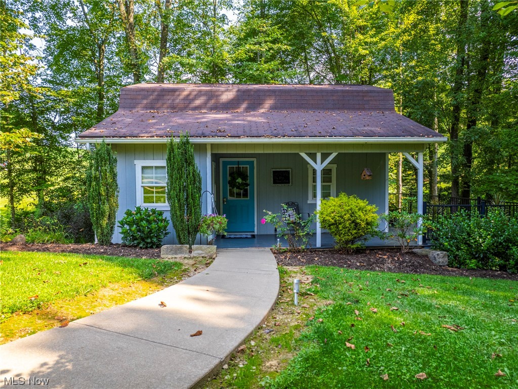 9452 Pleasant Hill Road Northwest Dundee, OH 44624 - Photo 28 of 35 Bungalow featuring a porch and a front lawn