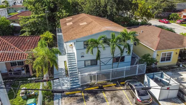 a view of backyard with swimming pool and outdoor seating