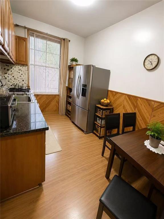 1564 Bay Ridge Avenue Brooklyn, NY 11219 - Photo 9 of 14 a kitchen with stainless steel appliances wooden floor sink and cabinets