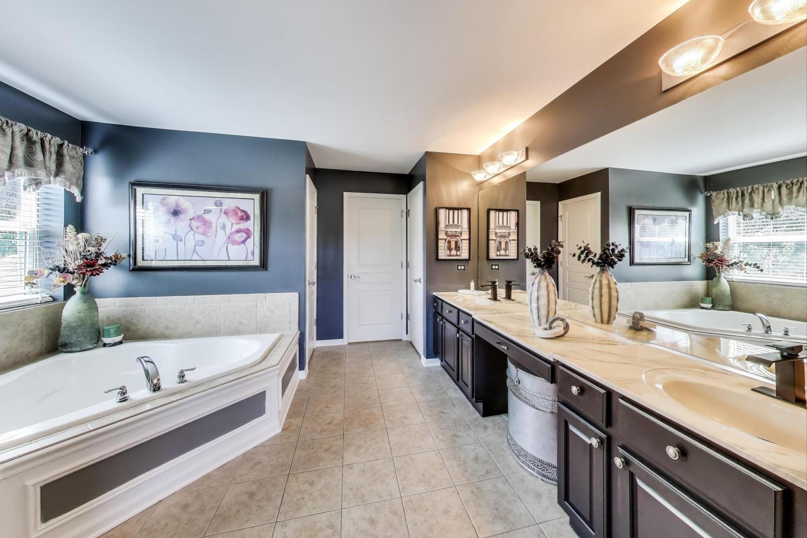 705 Porter Circle Lindenhurst, IL 60046 - Photo 15 of 34 a bathroom with a double vanity sink mirror and bathtub