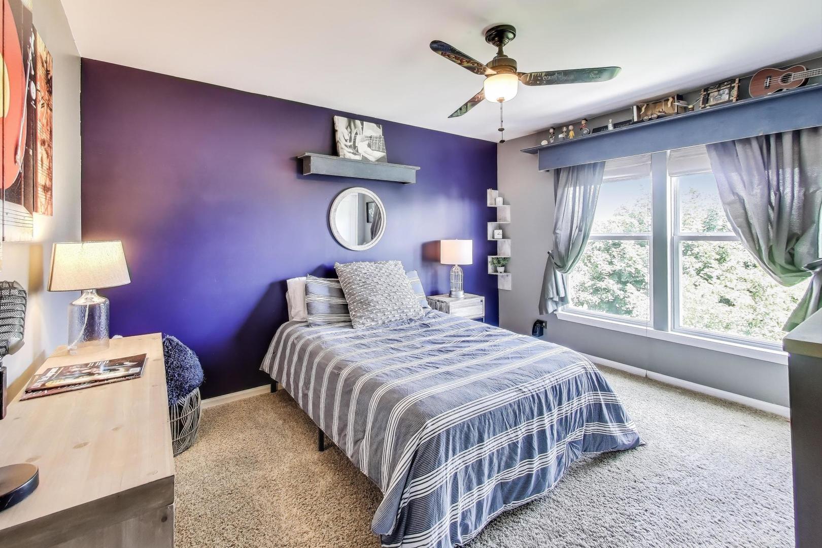 705 Porter Circle Lindenhurst, IL 60046 - Photo 20 of 34 a bedroom with a bed a window and a chandelier