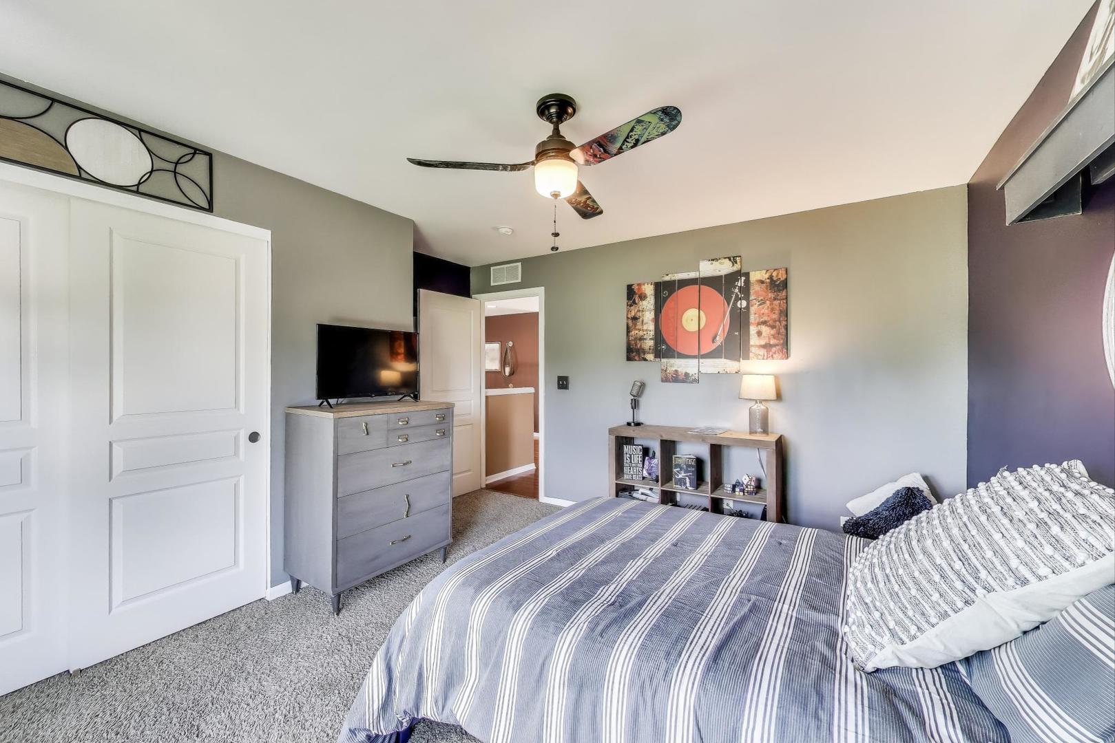 705 Porter Circle Lindenhurst, IL 60046 - Photo 21 of 34 a bedroom with a bed and a flat tv screen on dresser