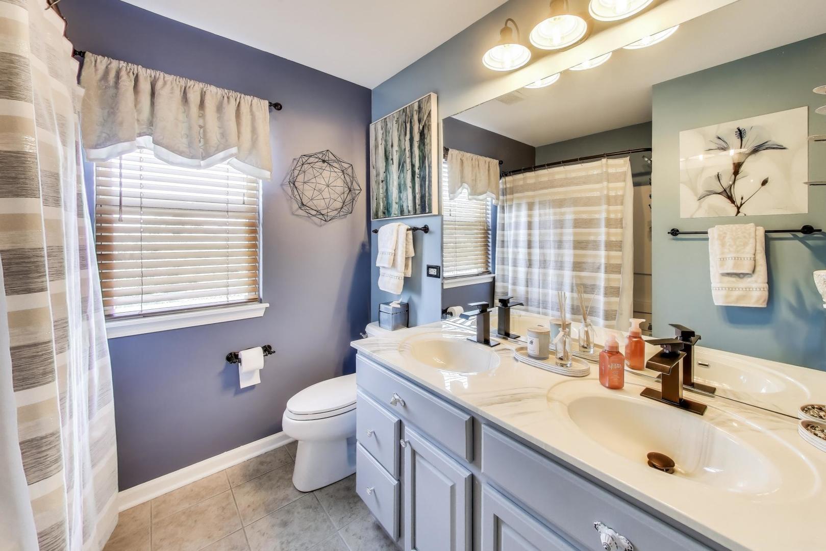 705 Porter Circle Lindenhurst, IL 60046 - Photo 22 of 34 a bathroom with a sink a toilet and a large mirror
