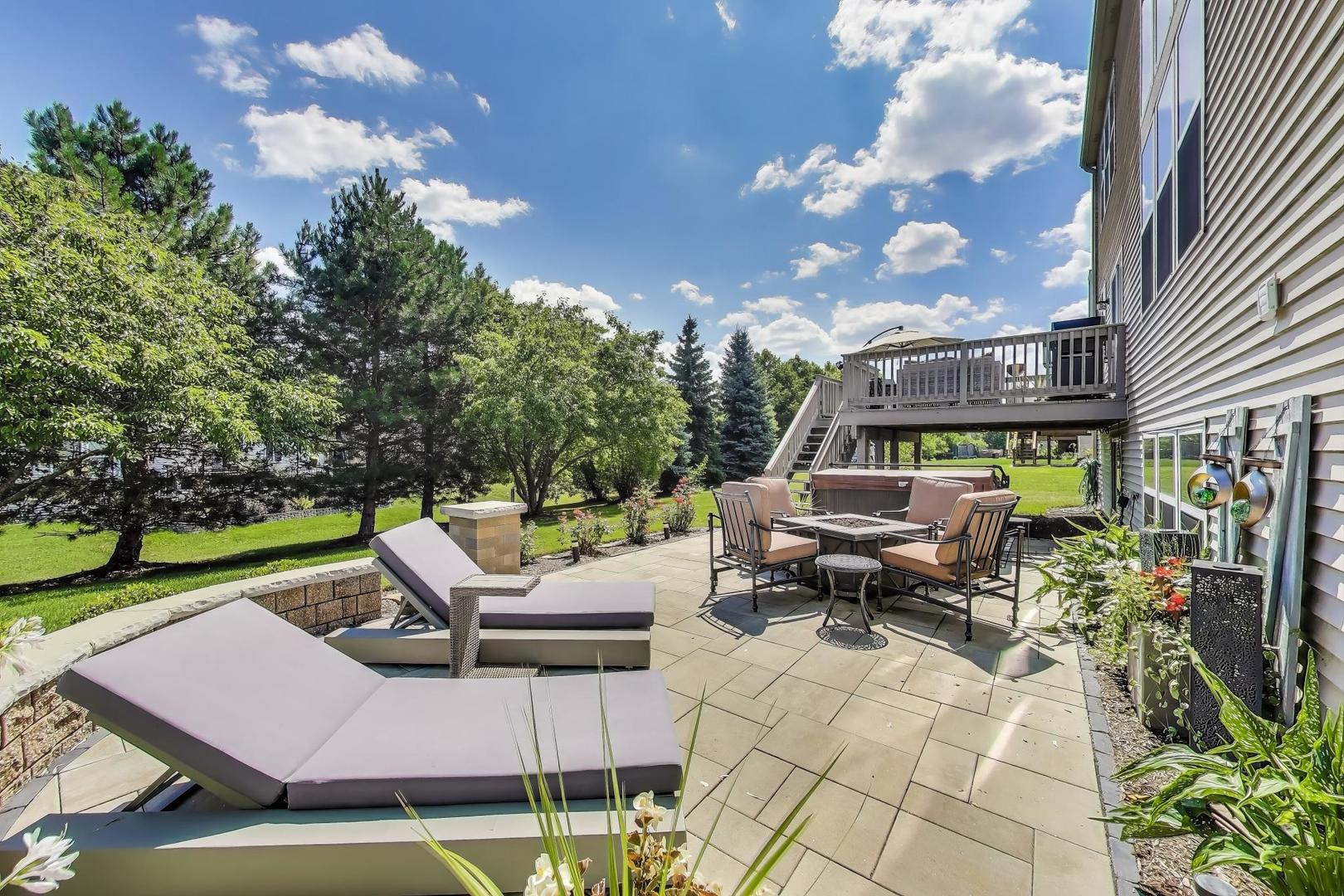 705 Porter Circle Lindenhurst, IL 60046 - Photo 32 of 34 a view of a patio with couches table and chairs and potted plants
