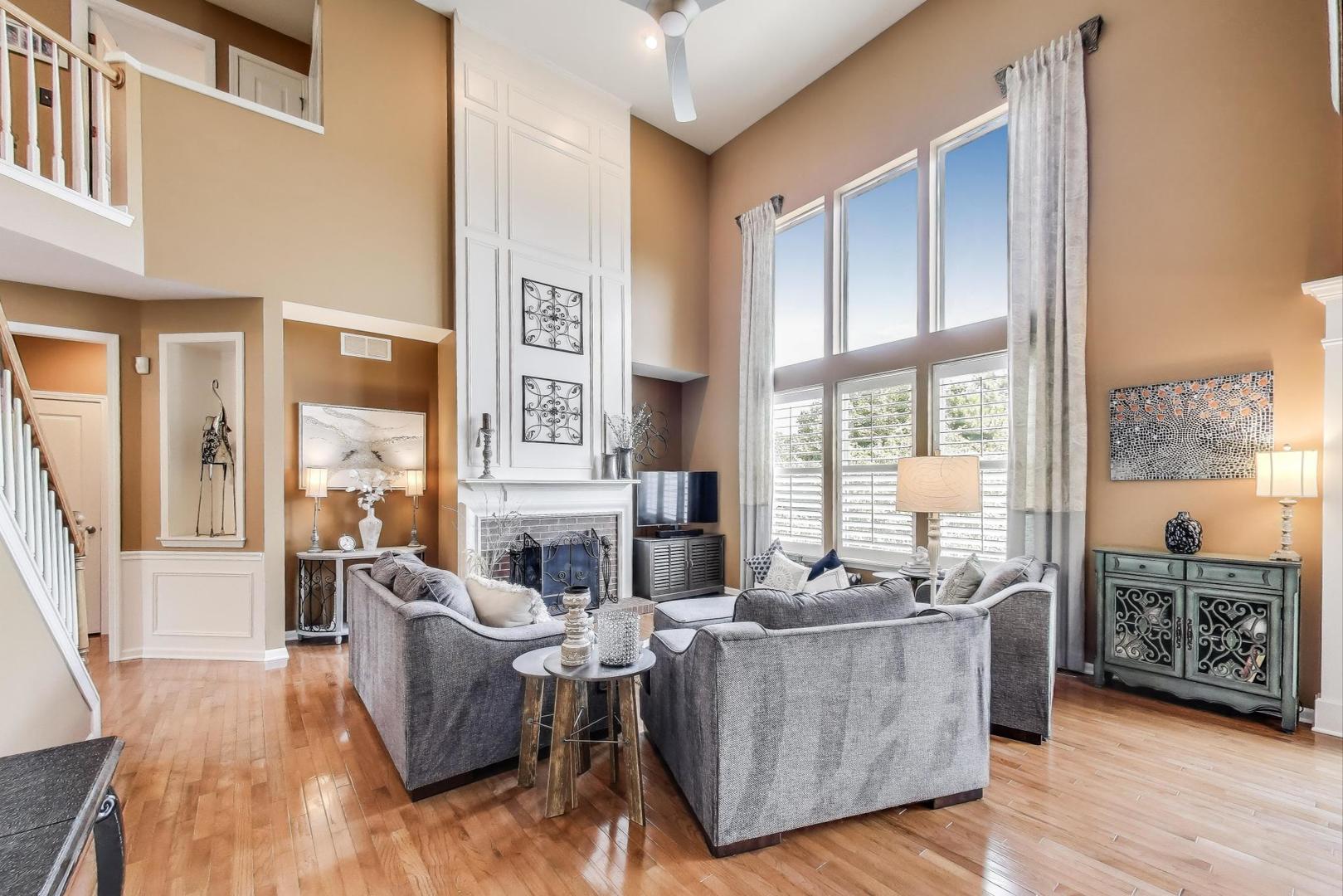 705 Porter Circle Lindenhurst, IL 60046 - Photo 8 of 34 a living room with fireplace furniture and a large window