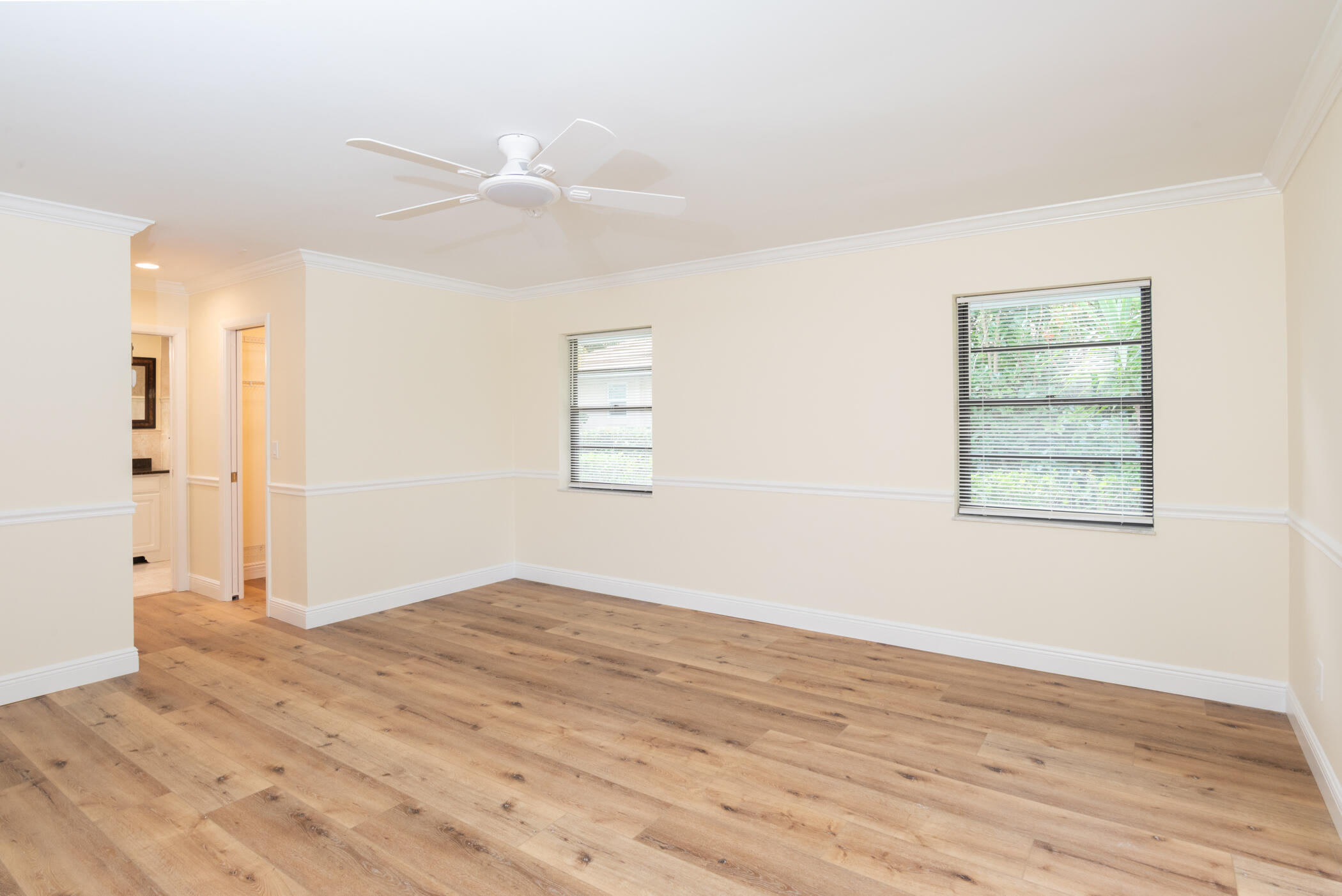 3201 Southeast Fairway West Stuart, FL 34997 - Photo 29 of 59 a view of empty room with wooden floor and fan