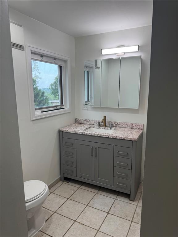 815 Braddock Road Pittsburgh, PA 15221 - Photo 21 of 36 a bathroom with a granite countertop sink mirror vanity and toilet