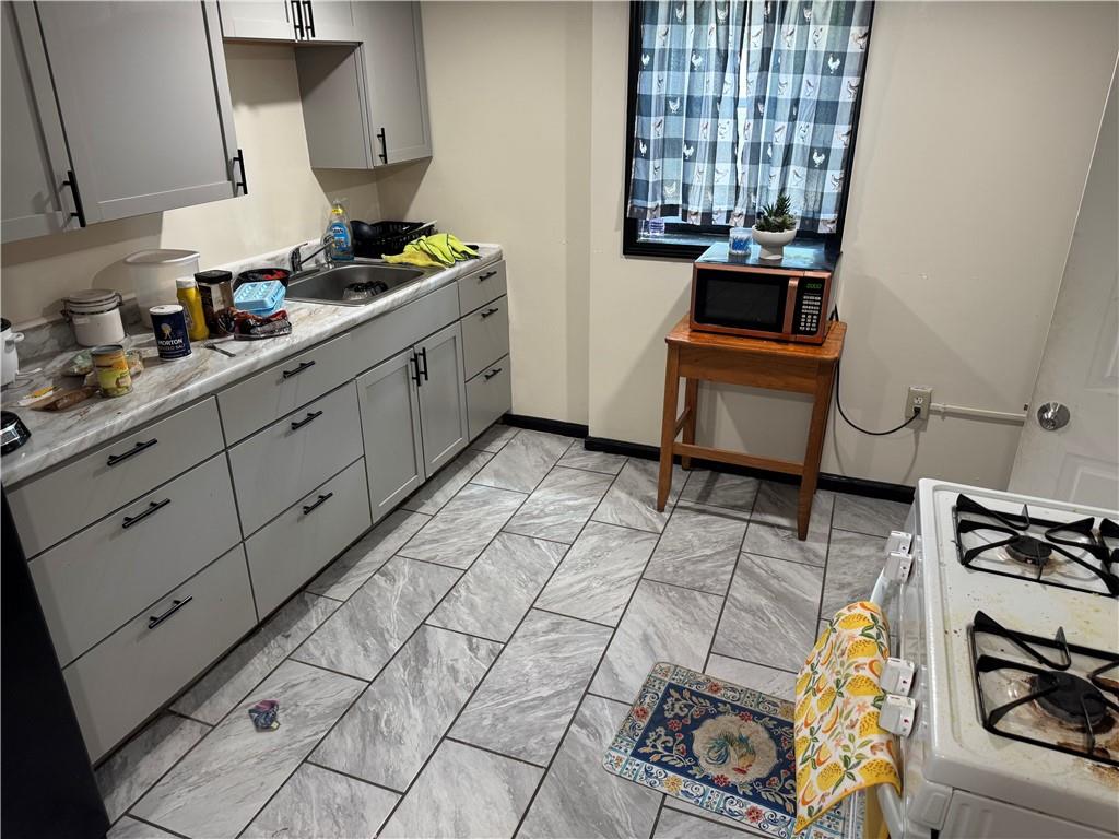 815 Braddock Road Pittsburgh, PA 15221 - Photo 27 of 36 a kitchen with stainless steel appliances a sink stove and cabinets