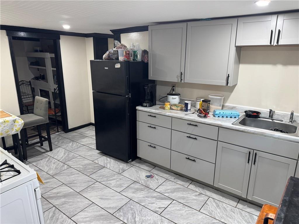 815 Braddock Road Pittsburgh, PA 15221 - Photo 30 of 36 a kitchen with a refrigerator and cabinets