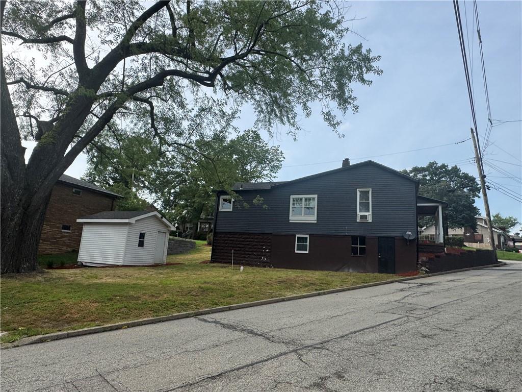 815 Braddock Road Pittsburgh, PA 15221 - Photo 7 of 36 a front view of a house with a yard and garage