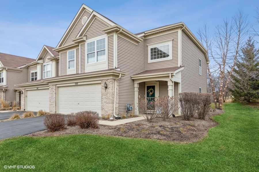a front view of a house with a yard and porch