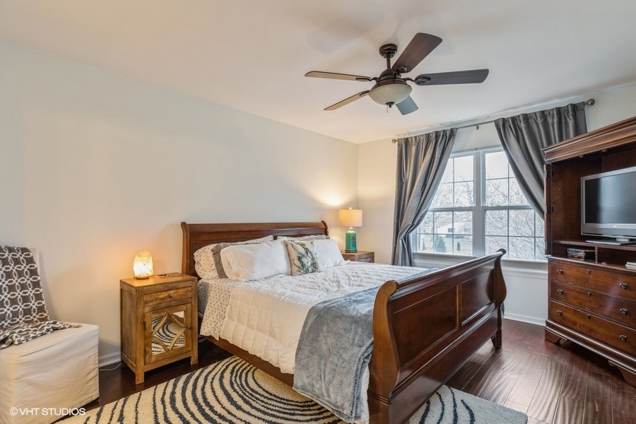 560 Lancaster Drive Pingree Grove, IL 60140 - Photo 11 of 26 a bedroom with a bed and a tv on the dresser