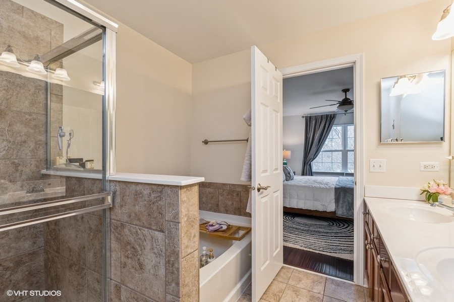 560 Lancaster Drive Pingree Grove, IL 60140 - Photo 13 of 26 a bathroom with a bathtub and a sink
