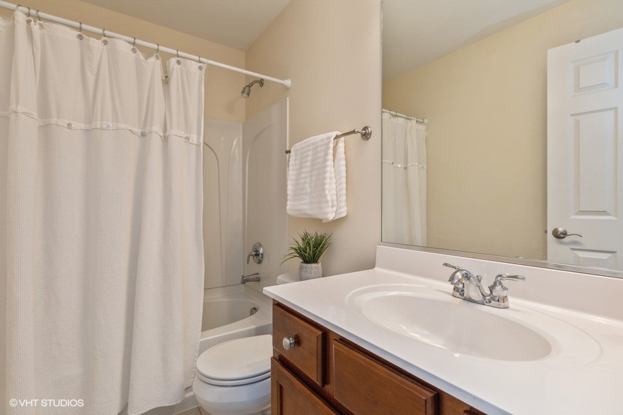 560 Lancaster Drive Pingree Grove, IL 60140 - Photo 14 of 26 a bathroom with a sink toilet and shower