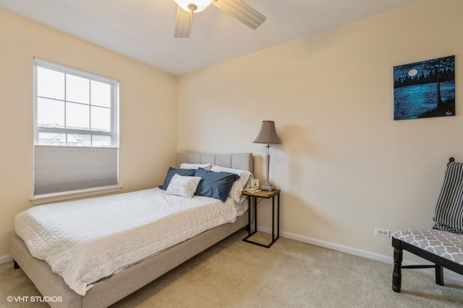560 Lancaster Drive Pingree Grove, IL 60140 - Photo 16 of 26 a bedroom with a bed and a television
