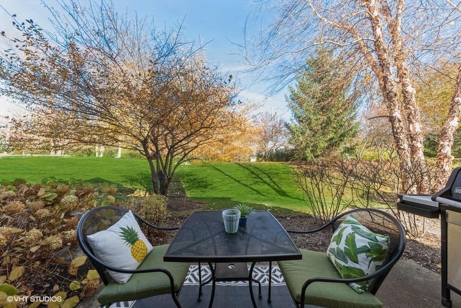560 Lancaster Drive Pingree Grove, IL 60140 - Photo 19 of 26 a backyard of a house with table and chairs