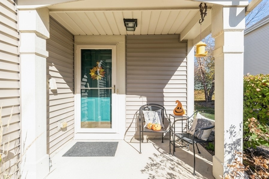 560 Lancaster Drive Pingree Grove, IL 60140 - Photo 2 of 26 a view of a balcony with chairs