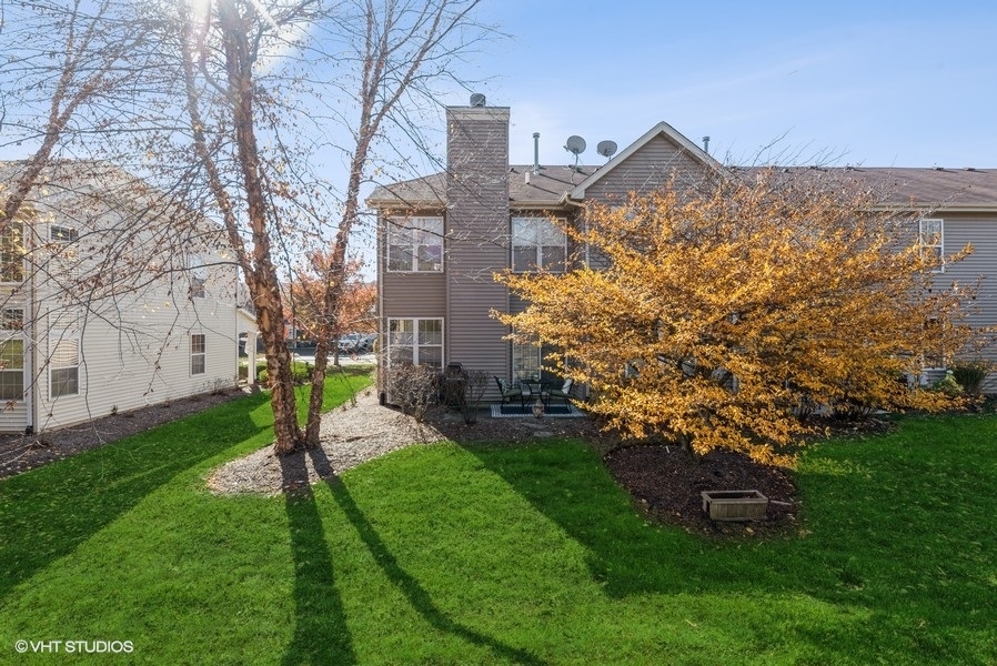 560 Lancaster Drive Pingree Grove, IL 60140 - Photo 22 of 26 a view of a house with a yard