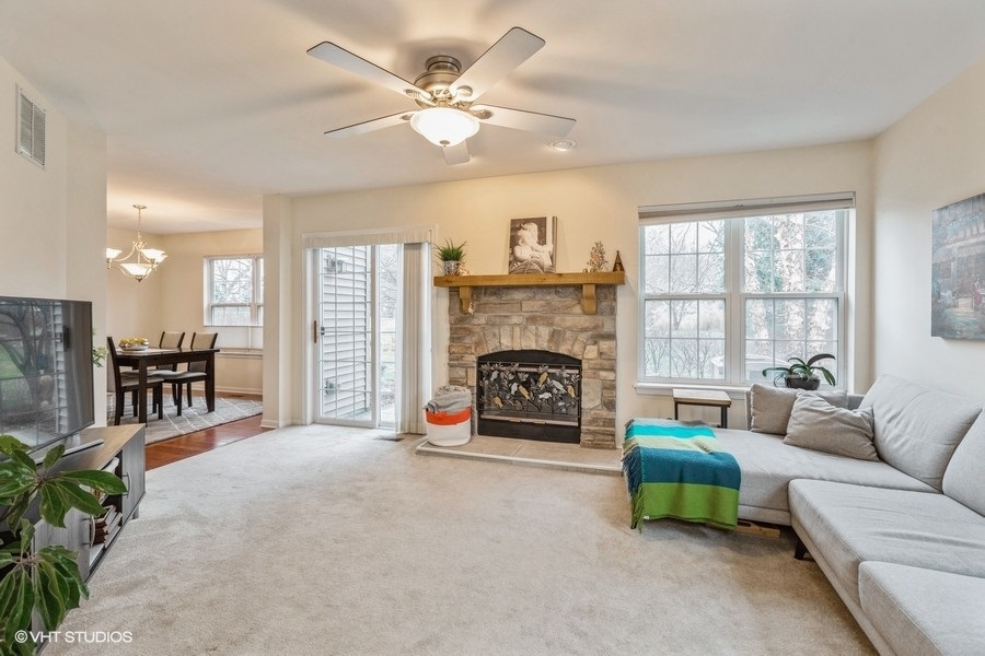 560 Lancaster Drive Pingree Grove, IL 60140 - Photo 8 of 26 a living room with furniture and a fireplace