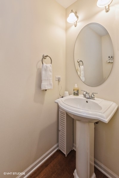 560 Lancaster Drive Pingree Grove, IL 60140 - Photo 9 of 26 wooden bathroom with a sink and mirror