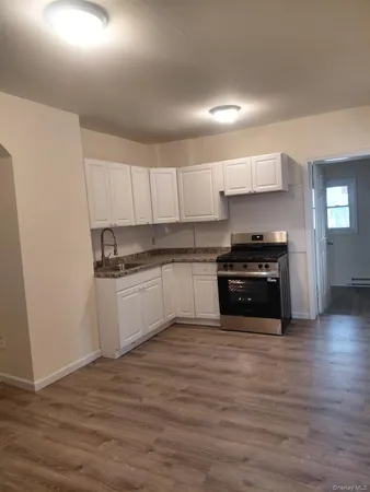 a kitchen with stainless steel appliances a stove top oven and cabinets