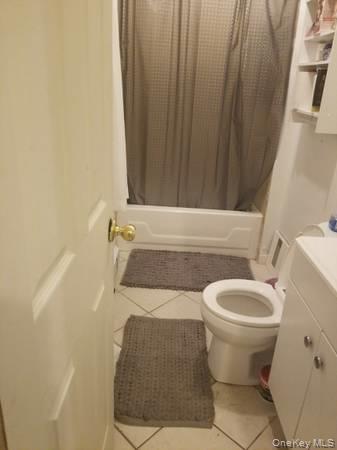 24 Franklindale Avenue, Unit 1 Wappingers Falls, NY 12590 - Photo 2 of 3 Full bath featuring light tile patterned flooring, vanity, and shower / bathtub combination with curtain