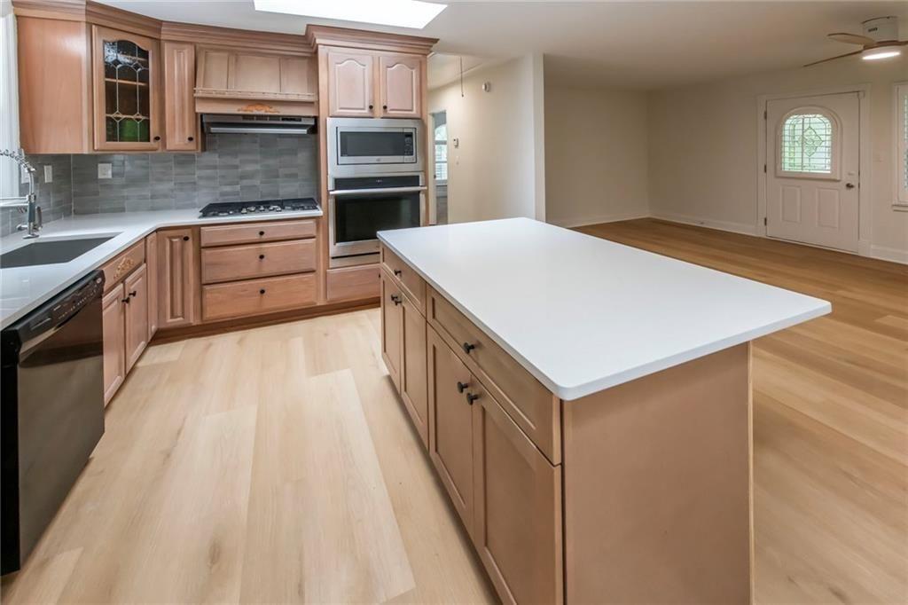 3819 Mason Creek Road Winston, GA 30187 - Photo 10 of 54 a kitchen with stainless steel appliances cabinets and wooden floor