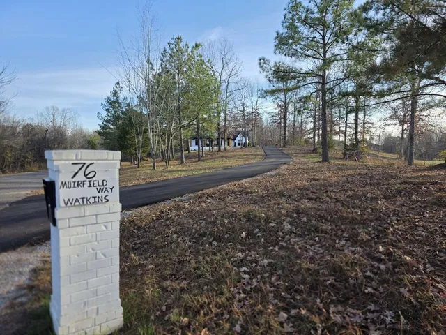 a view of a house with a backyard