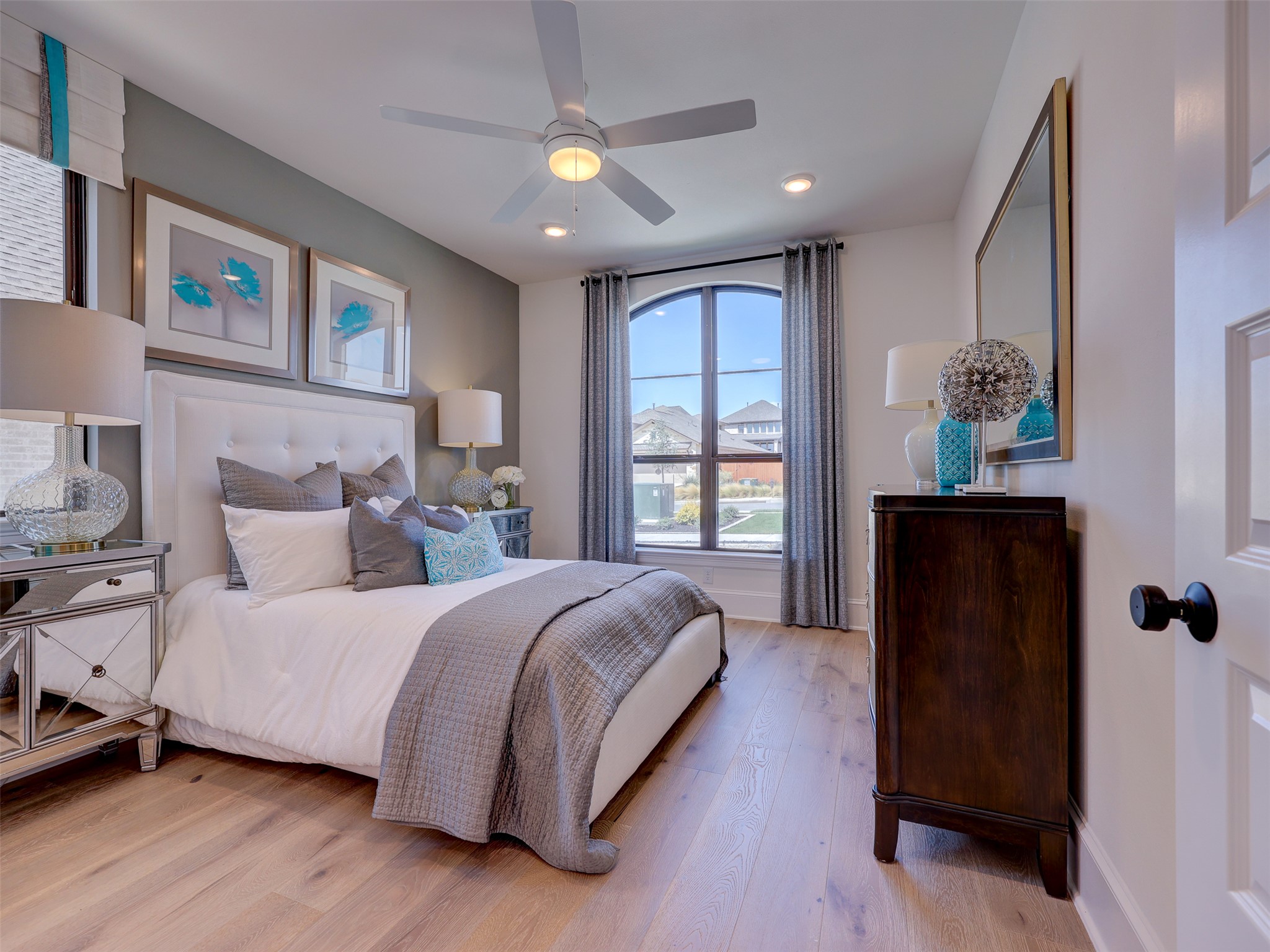 6220 Bower Well Road Austin, TX 78738 - Photo 15 of 28 Sun-filled bedroom featuring light wood floors and an elegant arched window.