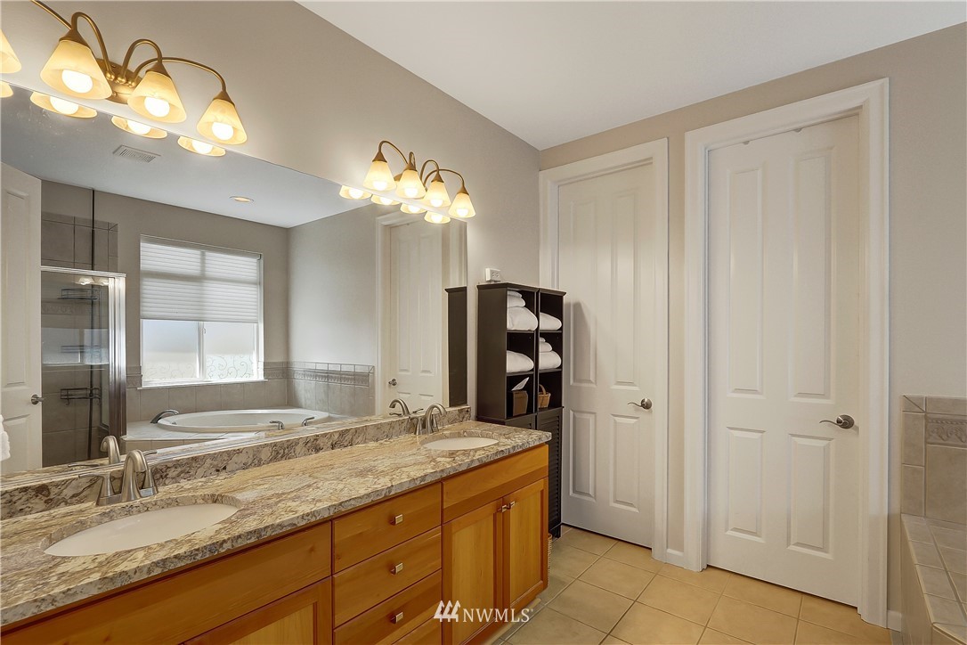 17025 164th Way Southeast Renton, WA 98058 - Photo 14 of 23 a bathroom with a granite countertop sink and a mirror