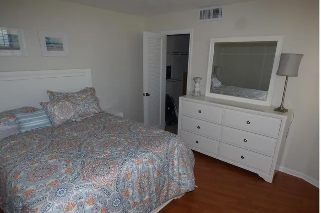 a bedroom with a bed and a mirror