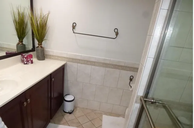 a bathroom with a sink a toilet and mirror