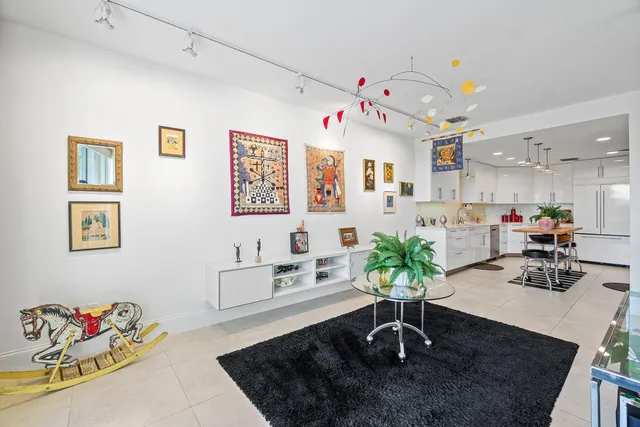 a living room with furniture flowerpot and a chandelier