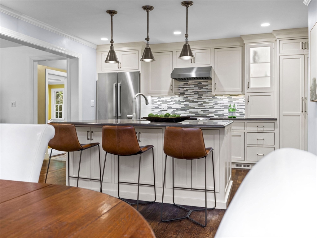 3 Dudley Road Wellesley, MA 02481 - Photo 5 of 25 a kitchen with stainless steel appliances kitchen island a chandelier