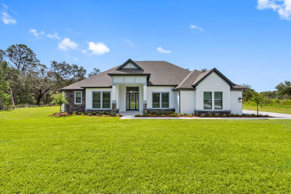 a front view of a house with swimming pool having outdoor seating