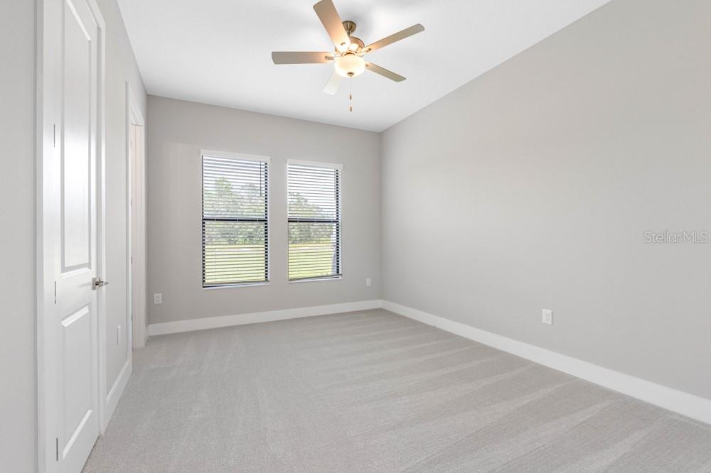13510 Haflinger Way Hudson, FL 34667 - Photo 11 of 13 an empty room with windows and fan