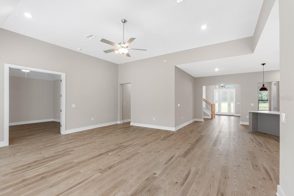 13510 Haflinger Way Hudson, FL 34667 - Photo 8 of 13 wooden floor in an empty room with a window