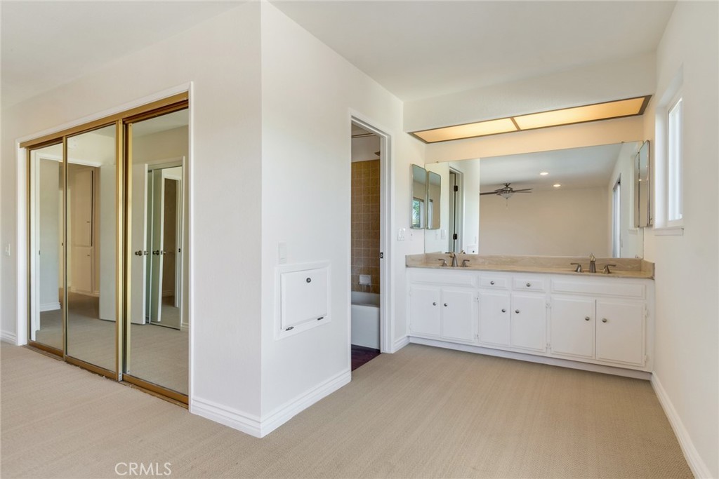 15750 Pounders Drive Riverside, CA 92504 - Photo 33 of 51 a spacious bathroom with a mirror sink and vanity