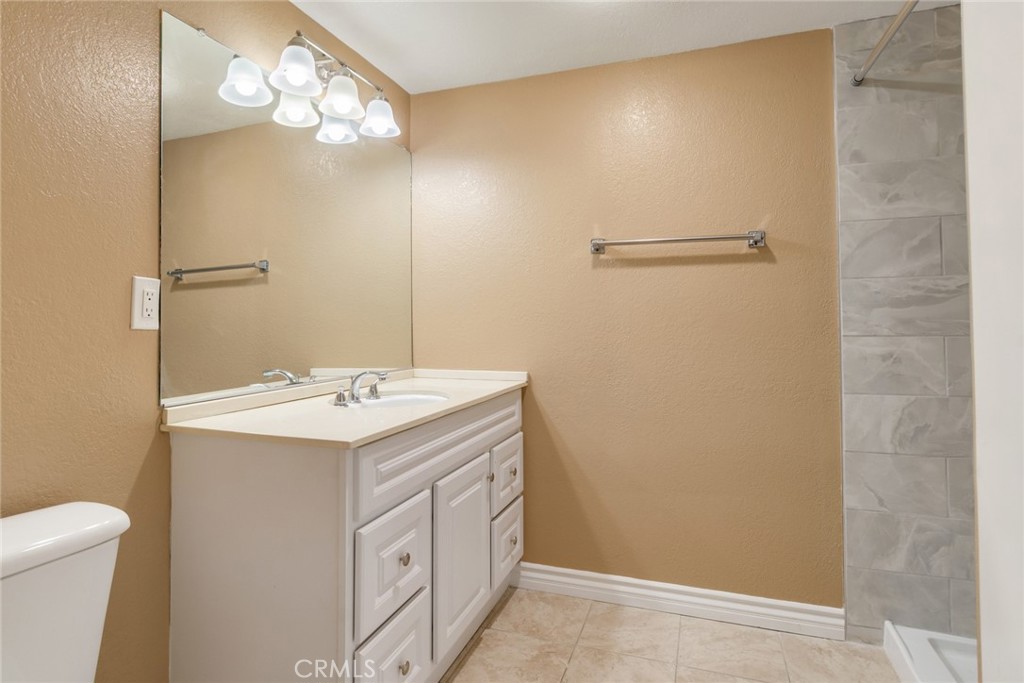 15750 Pounders Drive Riverside, CA 92504 - Photo 37 of 51 a bathroom with a sink and mirror