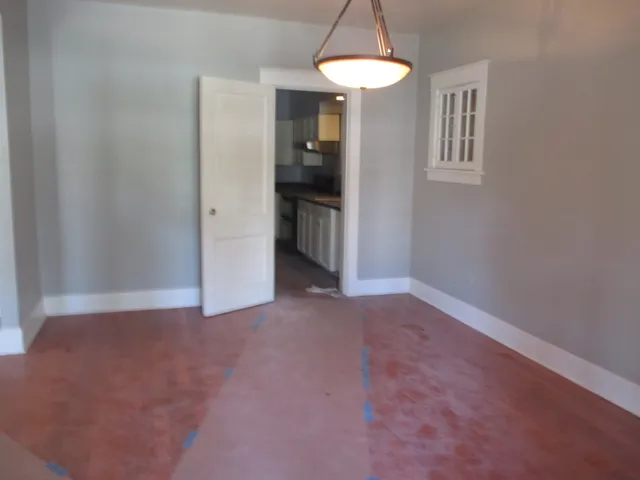 a view of a room with a stylish ceiling fan and entryway