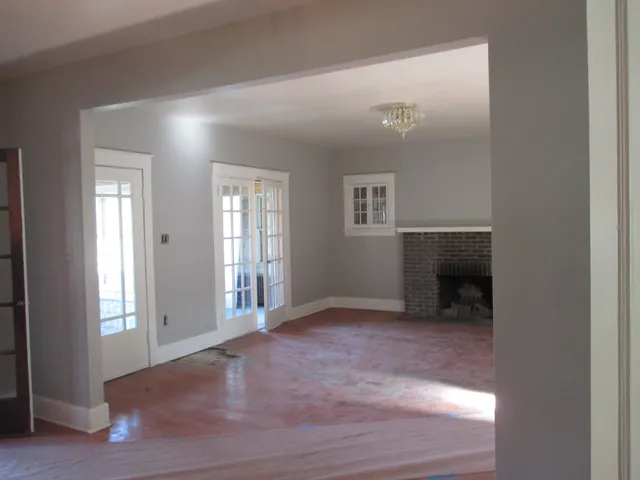 an empty room with windows and entrance