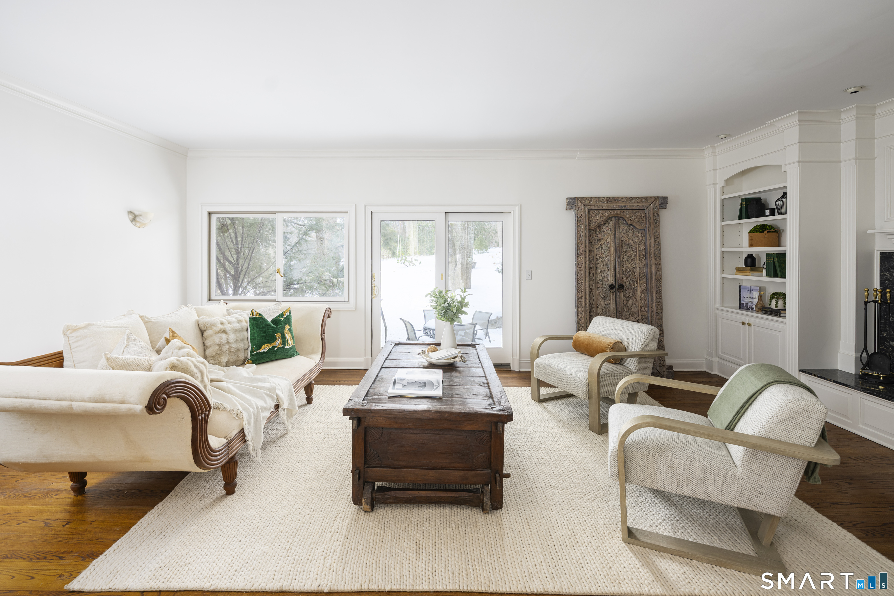 377 Main Street, Unit 17 New Canaan, CT 06840 - Photo 4 of 19 Sunken living room with fireplace and access to private patio at 377 Kings Grant unit 17